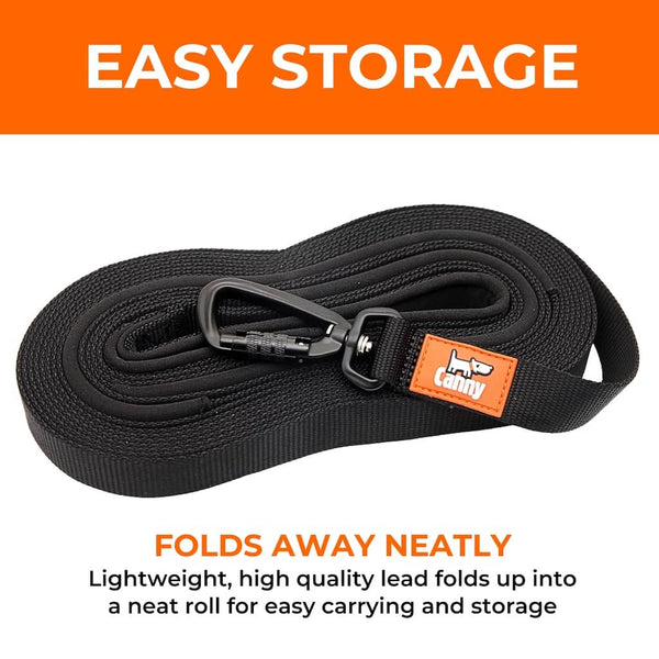 Coiled black Canny Recall Lead folded flat for compact, easy storage with locking carabiner visible on top.